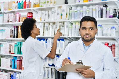 Male pharmacist holding clipboard