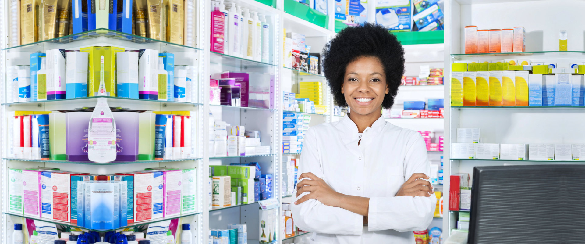 Smiling female chemist standing at the pharmacy